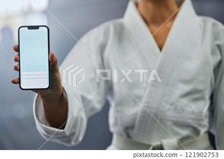 Sports marketing, advert and copy space on blank phone screen to signup for martial arts club training and exercise in gym. Closeup of karate trainer, sensei and coach endorse, recommend and promote 121902753