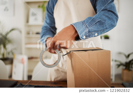 Packing, packaging and boxing product by wrapping in sellotape or duct tape and ready for shipping, selling or delivery. Closeup small business owner hands sealing package, order or gift for courier Packing, packaging and boxing product by wrapping in sellotape or duct tape and ready for shipping, selling or delivery. Closeup small business owner hands sealing package, order or gift for courier 121902832