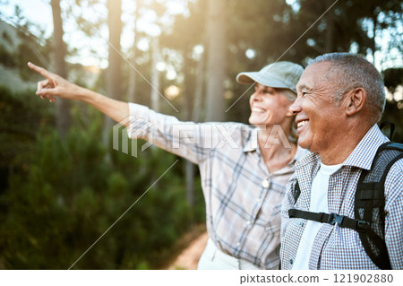 Hiking, adventure and freedom with a senior couple enjoying and exploring the forest or woods and bonding together. Happy, carefree and exploring retired man and woman looking at the views outdoors Hiking, adventure and freedom with a senior couple enjoying and exploring the forest or woods and bonding together. Happy, carefree and exploring retired man and woman looking at the views outdoors 121902880