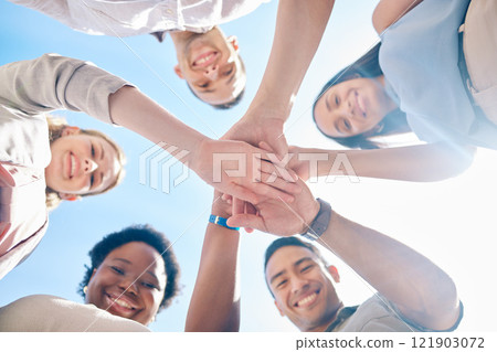 Group of friends hands stacked in success and unity from below for teamwork, collaboration and outdoors bonding. Diverse team showing support, togetherness and community, united for a common goal. 121903072