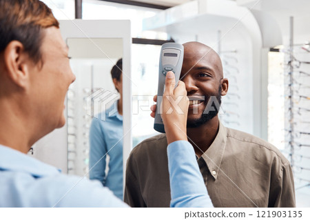 Eye exam, eyewear and an optometrist checking happy young male eyes with optic medical equipment. African man getting his eyesight checked by a tonometer. Smiling guy getting new spectacles. 121903135
