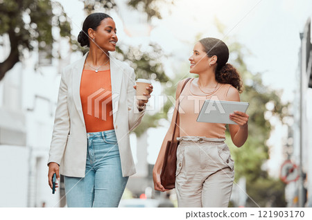 Startup entrepreneurs, female friends or design students discussing fashion project over coffee. Trendy stylish designers or girls walking together to agency in modern urban city with digital tablet 121903170