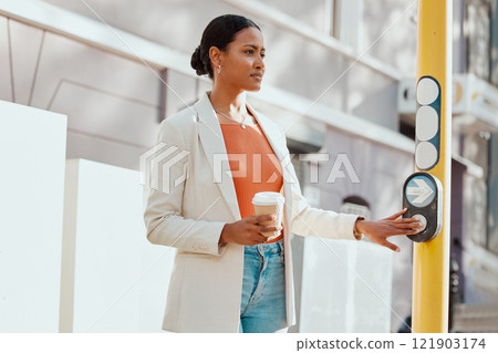 Crossing street, crosswalk or road at a pedestrian traffic light signal while waiting in a city outdoors. Young woman pressing button while traveling, commuting and walking in town on her way to work 121903174