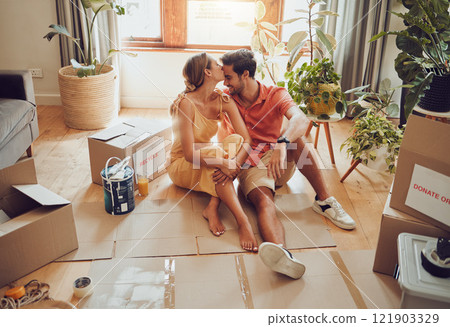New home owners moving into a house showing affectionate, taking a break from painting and remodeling the living room interior design. In love and loving house wife kissing husband after decorating New home owners moving into a house showing affectionate, taking a break from painting and remodeling the living room interior design. In love and loving house wife kissing husband after decorating 121903329