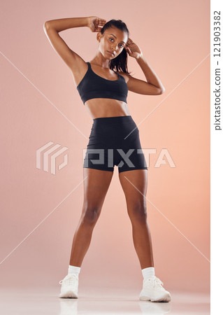 Beautiful, young and active fitness woman in sportswear with her arms up while tying her hair. Athletic female getting ready to workout at gym. Full length of attractive lady with healthy lifestyle. Beautiful, young and active fitness woman in sportswear with her arms up while tying her hair. Athletic female getting ready to workout at gym. Full length of attractive lady with healthy lifestyle. 121903382