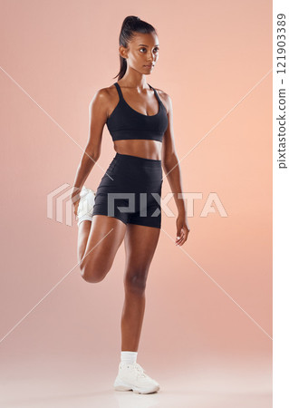 Fitness, exercise and workout athlete stretching out her legs before training indoors to stay healthy and young. Active, body and sporty woman warms up strong muscles for her motivated lifestyle Fitness, exercise and workout athlete stretching out her legs before training indoors to stay healthy and young. Active, body and sporty woman warms up strong muscles for her motivated lifestyle 121903389