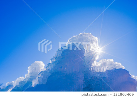 Ice sculpture and sunlight rays 121903409
