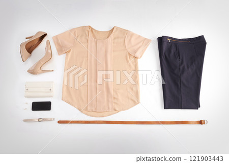 Women, fashion and clothes isolated on a white background in a room. Top view of a stylish, elegant and glamorous costume. Flat lay of trendy female apparel and a womans designer outfit from above. 121903443