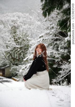 Woman walking in the snow Woman walking in the snow 121903549