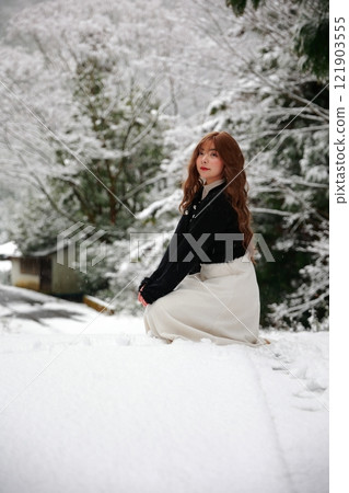 Woman walking in the snow Woman walking in the snow 121903555