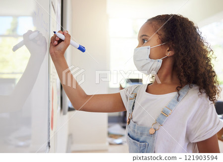 Smart, clever and intelligent girl writing an answer on a whiteboard at elementary school during the covid pandemic. Child development or quality education for a young kid learning in class Smart, clever and intelligent girl writing an answer on a whiteboard at elementary school during the covid pandemic. Child development or quality education for a young kid learning in class 121903594