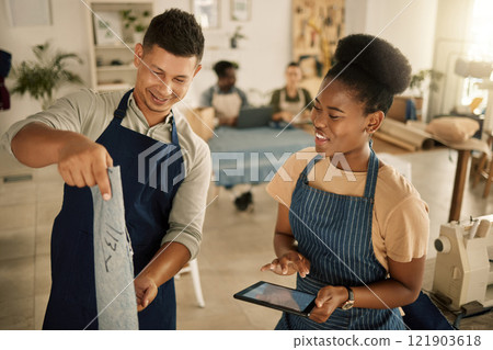 Tailor, seamstress and dressmaker talking with a colleague in a modern and creative design studio. Working together, teamwork and style with two designers planning and discussing trendy fashion ideas 121903618