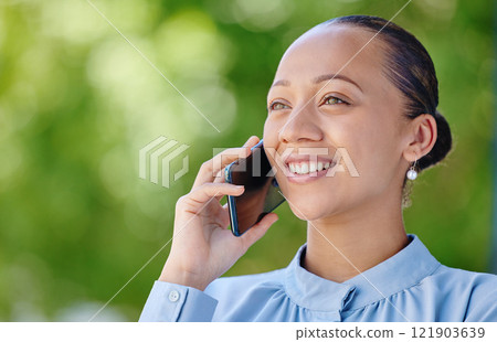 Woman calling, smiling and talking on a phone call while standing outside against green copy space. Happy, positive and ambitious woman with a positive mindset getting good news about insurance offer 121903639