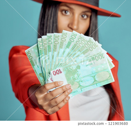 Rich, wealthy and stylish woman showing her money and success in fashion posing over copy space. Fashionable female advertising a cash prize or lottery win from a competition Rich, wealthy and stylish woman showing her money and success in fashion posing over copy space. Fashionable female advertising a cash prize or lottery win from a competition 121903680