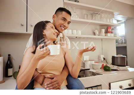 Happy, loving and romantic couple bonding, standing and hugging at home in the kitchen. Husband and wife talking, affection and enjoying feeling carefree while having a cup of coffee in the morning 121903689
