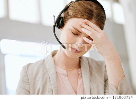 Burnout, headache and stressed call center agent working with problem, bad mental health or stressful job. Female sales representative or advisor feeling overworked, tired and exhausted 121903754