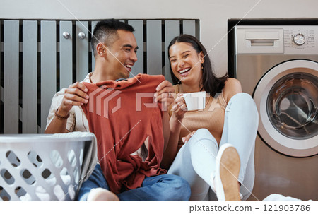 Carefree and funny couple doing laundry and relaxing together at home in the morning. Silly, goofy and playful lovers laughing and giggling while cleaning the washing, and doing house chores Carefree and funny couple doing laundry and relaxing together at home in the morning. Silly, goofy and playful lovers laughing and giggling while cleaning the washing, and doing house chores 121903786