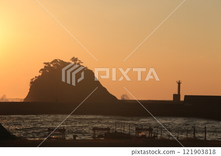 A beautiful sunset over the island at Nishina Port 121903818