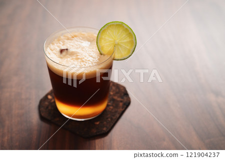 Espresso tonic in simple glass on walnut wood table with copy space Espresso tonic in simple glass on walnut wood table with copy space 121904237