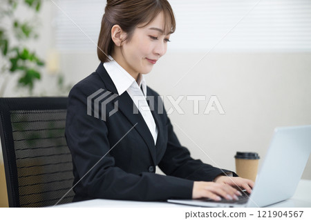 Young woman using a computer in the office 121904567