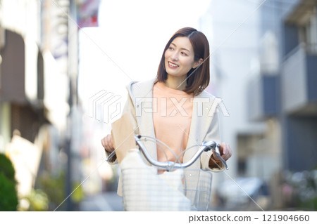 Middle-aged woman going shopping by bicycle Middle-aged woman going shopping by bicycle 121904660