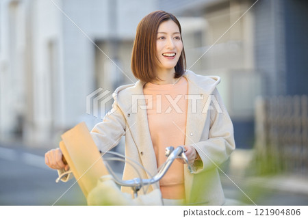 Middle-aged woman going shopping by bicycle Middle-aged woman going shopping by bicycle 121904806