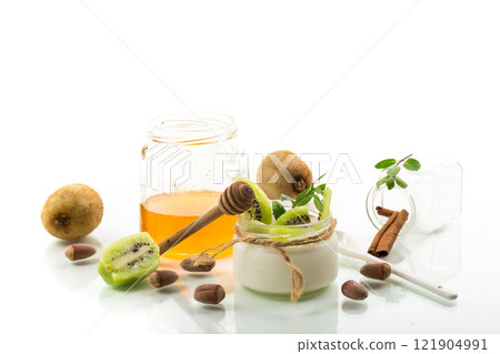 Homemade yogurt in a glass jar with honey, kiwi, nuts. Homemade yogurt in a glass jar with honey, kiwi, nuts. 121904991