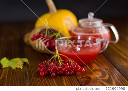 tea from ripe red viburnum on a wooden table tea from ripe red viburnum on a wooden table 121904998