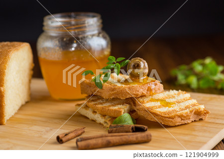 bread fried sweet toasts with honey on wooden board with cinnamon bread fried sweet toasts with honey on wooden board with cinnamon 121904999