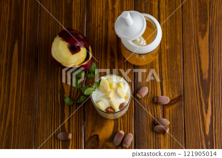 sweet homemade yogurt in a glass with apples, nuts and honey sweet homemade yogurt in a glass with apples, nuts and honey 121905014