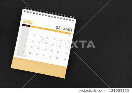 March 2025 desk calendar on black color leather background. March 2025 desk calendar on black color leather background. 121905160