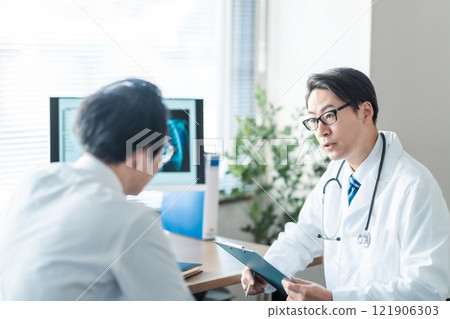 Middle-aged male doctor asking a question Middle-aged male doctor asking a question 121906303