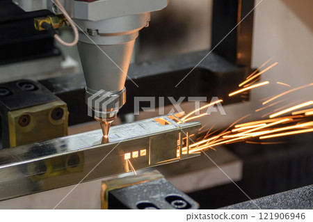 Close up scene the fiber laser cutting machine cut the square shape stainless steel tube with sparkling light. 121906946