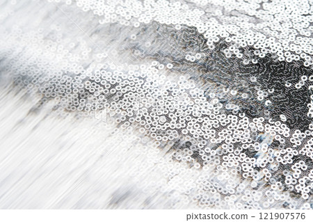 Abstract festive fabric texture with silver sequins. Abstract festive fabric texture with silver sequins. 121907576