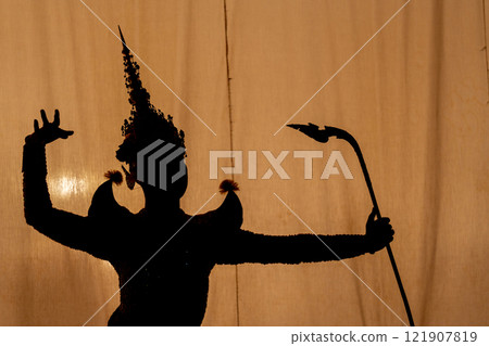 Close up Silhouette of Khon or Mask dance player stand with performance action in front of background with white screen. 121907819