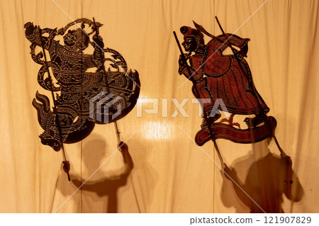 Two charactors of the shadow of grand shadow play with the player hold craft and stand behide the screen. 121907829