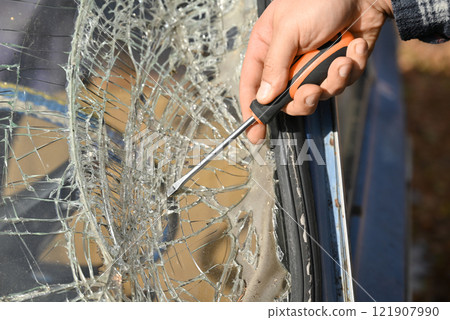 Repair of an old car that was in an accident, with broken windshield Repair of an old car that was in an accident, with broken windshield 121907990