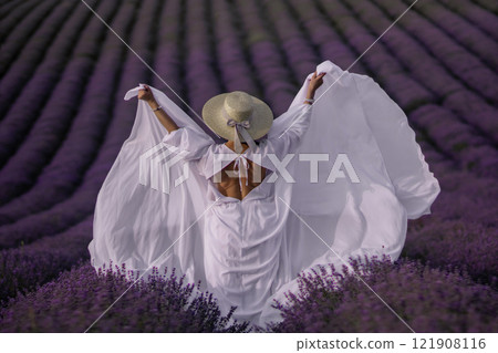 Lavender Fields Woman Dress: Provence France summer photoshoot; joyful woman celebrates nature's beauty. 121908116