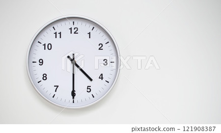 Minimalist White Clock with Silver Frame Striking 16.30/04.30 on White Background. Perfect for Time Management and Corporate Campaigns 121908387