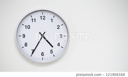 Minimalist White Clock with Silver Frame Striking 16.35/04.35 on White Background. Perfect for Time Management and Corporate Campaigns Minimalist White Clock with Silver Frame Striking 16.35/04.35 on White Background. Perfect for Time Management and Corporate Campaigns 121908388