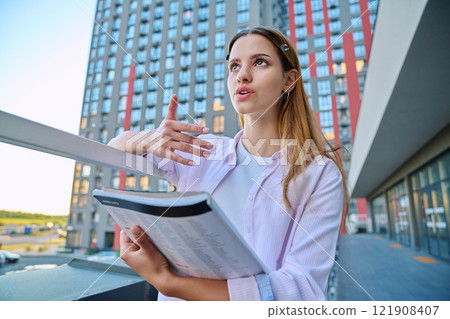 Webcam portrait young woman teenager looking talking listening to camera, outdoor Webcam portrait young woman teenager looking talking listening to camera, outdoor 121908407