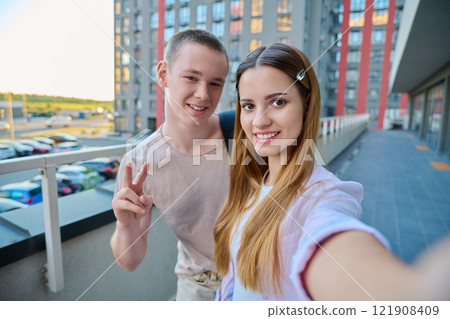 Selfie portrait of happy friends guy and girl college students looking at camera Selfie portrait of happy friends guy and girl college students looking at camera 121908409