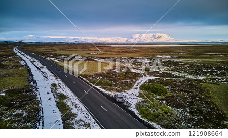 A road leading to snow-capped Lake Mývatn 121908664