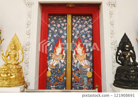 The red chapel door is eye-catching with a picture of the goddess wearing a Thai crown Represents contemporary Thai culture at Wat Naga Plok temple. The red chapel door is eye-catching with a picture of the goddess wearing a Thai crown Represents contemporary Thai culture at Wat Naga Plok temple. 121908691