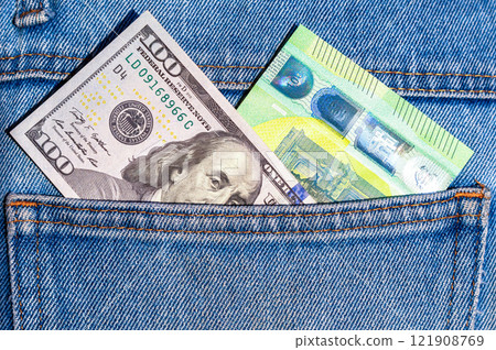 American dollars and euro banknotes sticking out of the back jeans pocket American dollars and euro banknotes sticking out of the back jeans pocket 121908769
