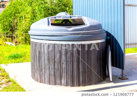 Big round garbage container for household waste at the city 121908777