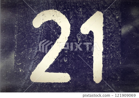 Number 21, White number on a dark background. Black and white old photo 121909069