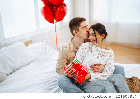 Exchange of gifts. Romantic day together. Valentines day, couple, relationships and people concept. 121909814