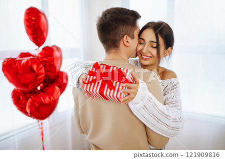Exchange of gifts. Romantic day together. Valentines day, couple, relationships and people concept. 121909816