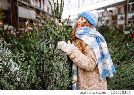 Happy woman buying a New Year tree for Christmas. Holiday concept, shopping. 121910205